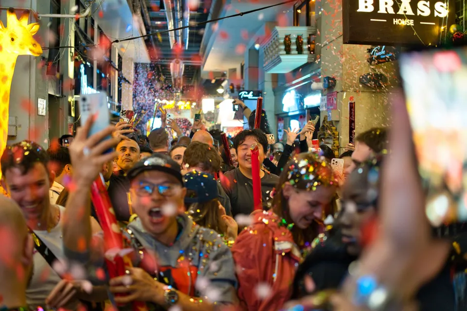 Confetti and cheering crowd in the street outside Brass House